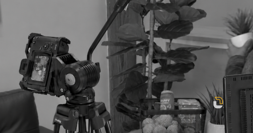 Camera on a tripod set up for a behind-the-scenes video shoot in a Link Creative studio