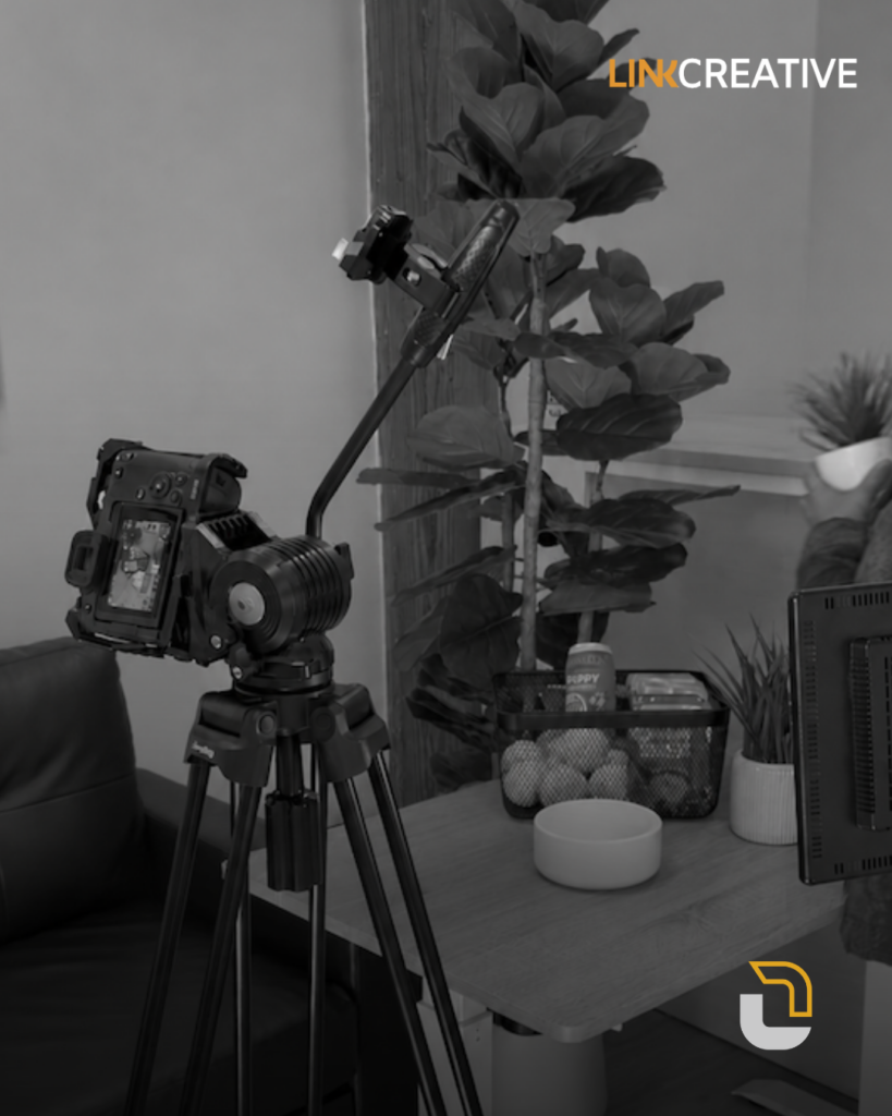 Mirrorless camera on a tripod beside a table and plants during a Link Creative content shoot.